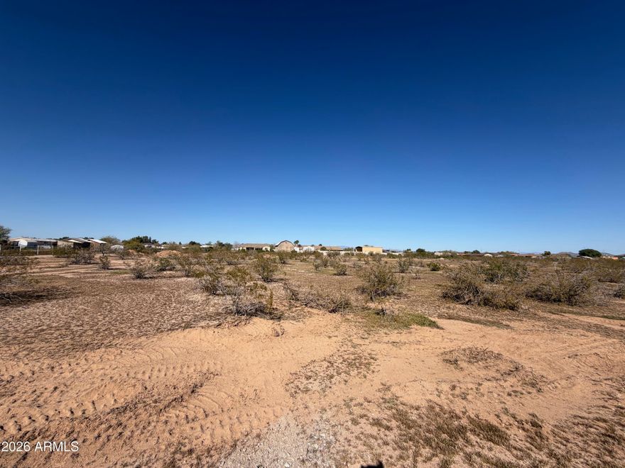 Exceptional 5.24 ACRE flat, buildable lot in growing Wittmann, AZ. Keep all 5 acres for your personal compound or split and sell for investment. Great builder opportunity! WELL IN! Electric near. NO flood zone, washes or Luke AF APZ.  Surrounded by custom homes/ranches. Room for spacious home PLUS RV garage PLUS guest house PLUS horses and all the toys. No HOA, but deed restricted to site-built homes 1900+sf.  Improved road and shared easement to parcels. Approx 1 mile to US 60 -- EZ access to 303, Lake Pleasant, Shopping, Dining, and a quick trip to Vegas. Buyer to verify all info. Septic will be needed. Seller may carry, ask for terms.