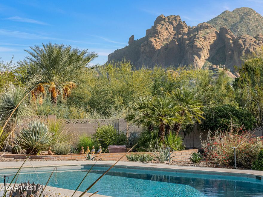 Tucked within the heart of Paradise Valley, this refined Southwestern Modern residence offers a serene blend of luxury and relaxed elegance, centered around a tranquil courtyard and soothing water features that create a true private oasis. Designed with effortless flow, the split floor plan highlights a stunning, newly updated primary suite, a true designer showcase, while thoughtfully curated interiors invite both comfort and sophistication. The chef's kitchen is a masterpiece of form and function, featuring professional grade design and top-tier appliances, including three ovens, a Teppanyaki side plate, warming drawers, and an integrated espresso machine. Entertaining is effortless with a generous dining room, multiple courtyards and patios, and a beautifully appointed detached casita featuring one bedroom and one bathroomperfect for guests seeking privacy and comfort. Each space is thoughtfully positioned to embrace views of Camelback Mountain and the peaceful sounds of water flowing through the property. The primary suite is a luxurious retreat, complete with a cozy gas fireplace and a breathtaking bathroom featuring a walk-in shower, spa-inspired design, and a massive walk-in closet. A built-in television within the mirror ensures you never miss the news or your favorite game, even while getting ready. Set on over an acre, the grounds showcase a recently updated pool and spa surrounded by mature landscaping and expansive entertaining areas, perfect for hosting or unwinding in complete privacy. Additional features include a temperature-controlled wine cellar, prep kitchen, oversized laundry room, and a rare four-car garage. This is refined Arizona elegance at its finestwhere tranquil courtyards, flowing water, and timeless design define luxurious Paradise Valley living.