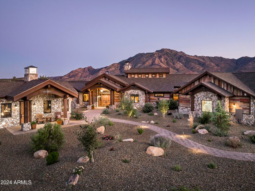 Exquisite Mountain Ranch Estate, perfectly positioned on 1.87 acres at the base of Granite Mountain, behind the gates of exclusive American Ranch Equestrian Community. Architecturally wrapped w/ reclaimed barn wood siding & stone exterior, this 4,369 sq. ft. estate is stunning inside & out! Main house offers 3 bed plus office, 4 bath, boasting only the finest of features w/ floor to ceiling double sided see thru stone Accucraft fireplace, arched beams w/ wood ceilings, milled live edge wood accent walls, built in custom cabinetry, custom Wyoming lighting, Kolbe windows & sliders, solid alder wood doors & trim, whole house sound system, heated tile flooring, accent tin ceilings, Nuvo water filtration, fire suppression system, hickory hardwood flooring w/ brick & stone accents See MORE. throughout. Chef's kitchen is equipped w/ oversized black walnut island, copper sink & range hood, Wolfe/Sub Zero Appliances w/ 6 burner range & griddle, pot filler, double oven, walk-in pantry w/ wine storage. Expansive primary suite w/ quaint reading niche & cozy fireplace, huge walk-in closet w/ granite counter built in dresser. Grand primary bathroom offering walk-in thru shower, copper soaking tub & sinks. 555 sq. ft. Guest House is adorned w/ the same attention to detail offering kitchen, den w/ see thru fireplace, 1 bed, 1 bath. Oversized 3 car garage w/ epoxy floors, climate control, walled in storage room & upstairs loft. Enjoy captivating mountain views from wrap around rear patio all under roof w/ wood burning fireplace, built-in BBQ, water feature, fenced yard for pets, & spa connection off primary. Community offers clubhouse, outdoor pool, tennis courts/pickleball, fitness center, cardio room, billiards room, fully stocked fishing lake & the multi-million dollar fully staffed equestrian center and more!