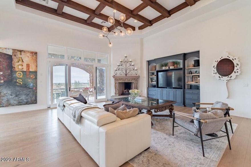 This fully renovated and stunning hillside estate, located in Ancala Country Club, boasts soaring detailed ceilings, expansive walls of glass and breathtaking Camelback Mountain and city light views.

No expense was spared during the remodel that features luxurious finishes throughout. New 9' wide white oak floors, a remodeled kitchen, bathrooms and laundry room along with recent paint inside and out.  A Chef's kitchen with marble countertops, features, two large islands with top of the line appliances including two sinks and dishwashers, side by side Sub Zero refrigerator and freezer, A Wolf range, wall oven, microwave and warming drawer topped off with a wine refrigerator and all encompassed by beautiful detailed white cabinetry. The Kitchen is open to the great room that is adorned... with a carved stone fireplace 12' sliding door that open up to a huge patio, creating the indoor outdoor living and overlooking the pool and city views that go as far as the eye can see. 

A grand primary suite with a carved stone fireplace and a renovated primary bath featuring Bianco Carrara marble floors and shower a free standing tub and marble countertops.  The main home has 4 spacious bedrooms (one is currently being used as a gym) with 5 bathrooms. Additionally, there is a large 2nd family room on the lower level that is perfect for entertaining including wainscotting and crown molding, a fireplace, a large wet bar with ice maker and dishwasher and a temperature controlled glass wine wall.

The renovated detached casita has a kitchenette, cozy living space a large bedroom and full bathroom. 

This hillside estate is a must see for the most discerning buyer.