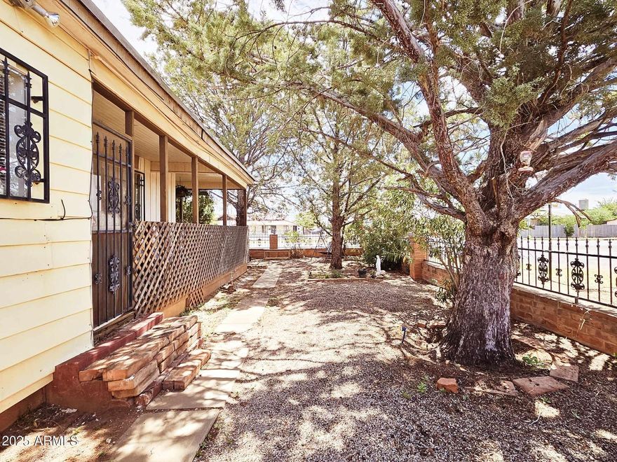 Discover the perfect balance of historic charm & comfort in this unique 3-bedroom, 2-bathroom home, nestled in the heart of Naco, Arizona. Ideally located for professionals commuting to Naco, Mexico, this property also offers excellent rental potential, making it a smart choice for both homeowners and investors. Step onto the expansive wraparound porch & enjoy peaceful mornings with coffee or relaxed evenings surrounded by the quiet ambiance of Naco. Inside, you'll find three spacious bedrooms & two updated bathrooms designed for modern living. The large block-walled yard, complete with mature trees, provides shade, privacy, & a safe space for children & pets to play. With its blend of character, convenience, and investment opportunity, this home is truly one-of-a-kind.