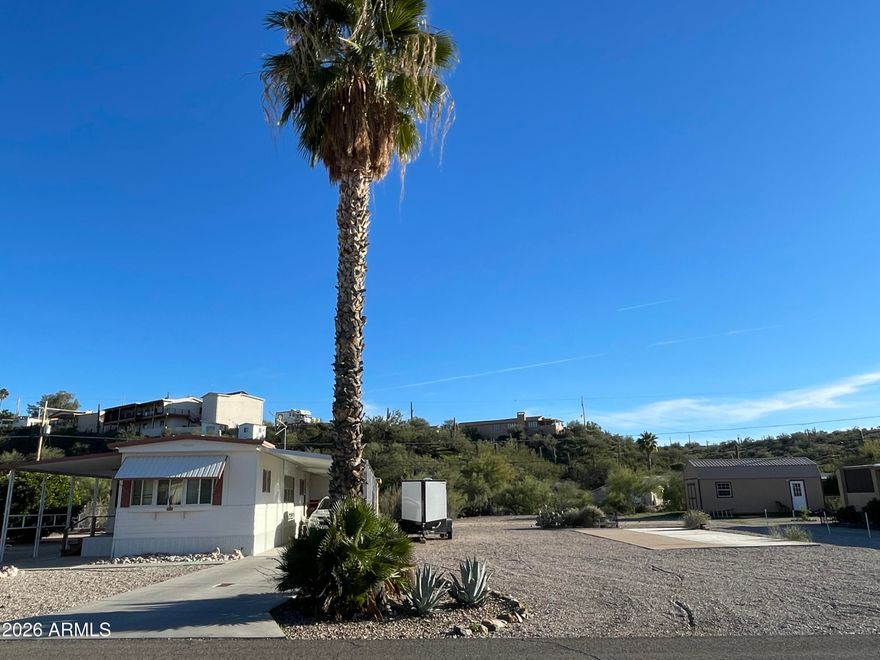 Two lots! This well maintained home comes with an additional lot that has a concrete pad, and its own septic ready for your RV parking, build a garage, shop, or split it off for revenue.  Enjoy being outside with fruit trees, a fenced off garden area, and room to create your own backyard oasis. The home is a two bedroom one bath with nice updates. The bathroom has newer flooring and counters. The kitchen has plenty of storage with lovely new cabinets, newer appliances and updated flooring that extends into the dining room. The laundry room is off the primary bedroom offering additional room for storage or a workshop. The garage is accessed from the back of the property with walk through door on the coverage front patio. The home is being sold furnished.