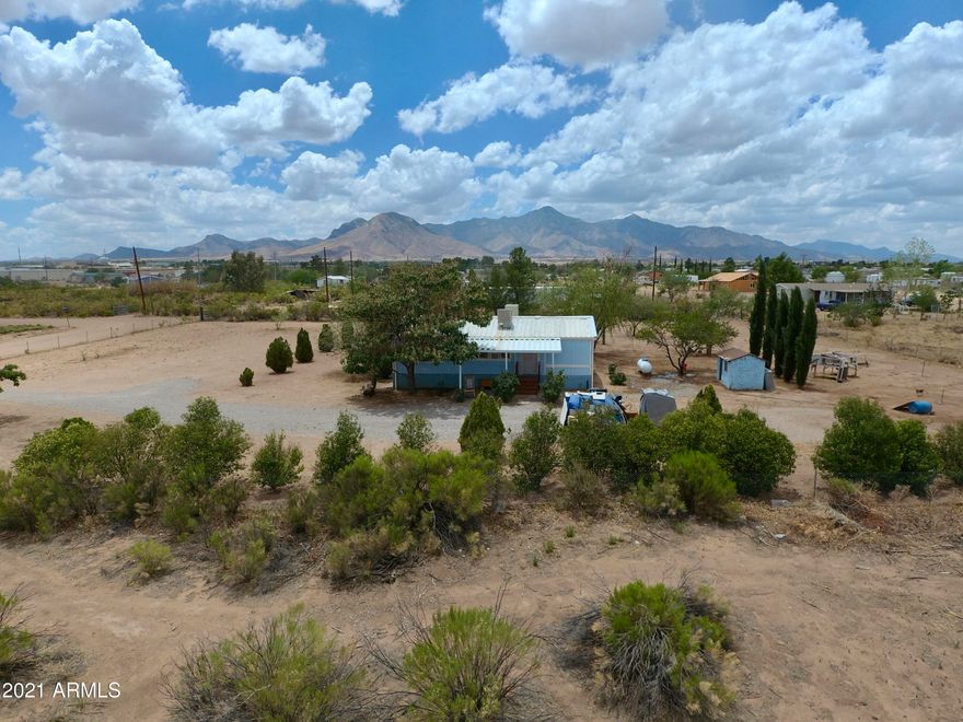 Adorable 3 bedroom, 2 bathroom home that sits on a little over one acre.  The home has the Affidavit of Affixture, has engineered tie downs, and septic inspection. No HOA, limited CC&R's.  Wonderful mountain views of the Huachucas, Mules and even Chiricahua in the distance on a clear day.  Short drive off of a paved road, gated entrance, and fully fenced property.
