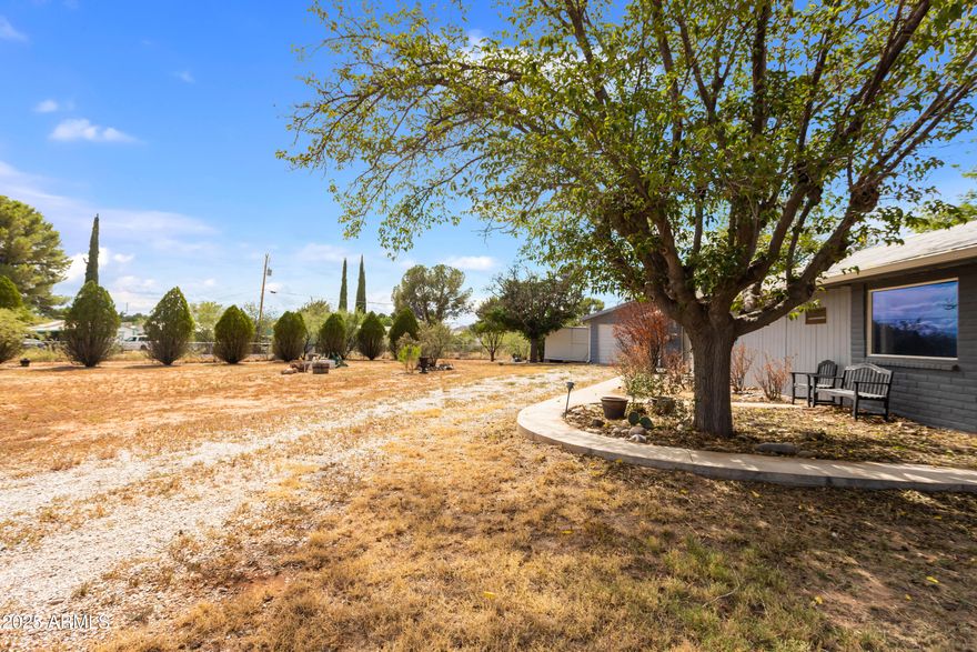 Enjoy peaceful desert living with panoramic mountain views in this spacious 3-bedroom, 2-bathroom home located in the quiet community of Dragoon. Set on a generous lot, this property offers a well-designed split floor plan with two large living areas—ideal for flexible living, entertaining, or multi-generational use. Inside, the open-concept kitchen features upgraded cabinetry with sliding shelves and a built-in lazy Susan, providing smart storage and easy access. The kitchen flows into the dining and living areas, creating a welcoming and functional space for daily living. Property is equipped for a variety of needs. A detached one-car garage provides covered parking or extra storage, while a large workshop offers space for hobbies, or home-based projects. Located 20 minutes from Benson