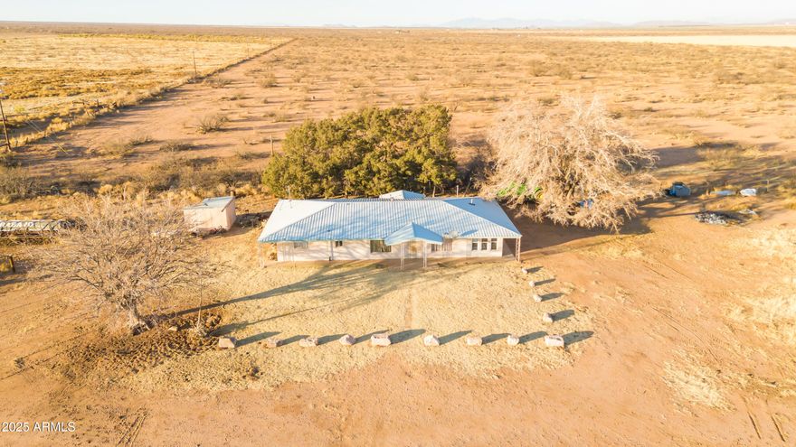 Prime Irrigated Farm with Spacious Home - Ready for Farming! This 165 ac irrigated farm in the AMA is a rare find, offering two irrigation wells with 140 acres of irrigation rights, a full pivot system & leveled fields, making it ideal for high-yield farming. The property is easily accessible via a paved road & features natural gas for efficiency. This spacious home is designed for comfort, boasting tile flooring throughout & a durable metal roof. A versatile family room, currently used as a 4th bedroom, includes an attached storage room for convenient storage. Located just minutes from Elfrida, this farm provides quick access to schools, a health clinic & shopping. Whether expanding an operation or starting fresh, this turnkey farm is ready for success. Seize this rare opportunity!