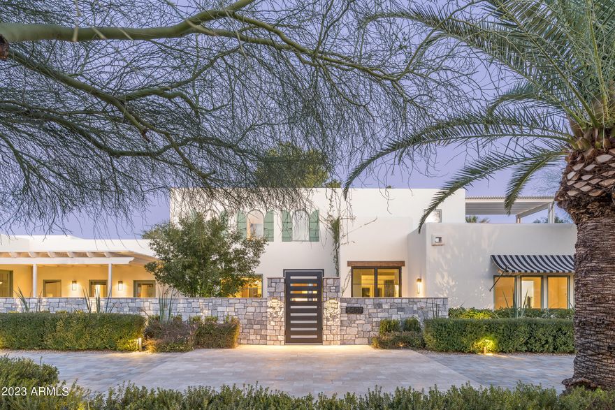 This beautiful house is an eclectic and one-of-a-kind mix of old and new: wood beamed ceilings with tongue & groove details, flagstone floors and block construction meet bright white walls, a  luxurious newer owner's suite, complete with
a cozy den & gas fireplace. and an abundance of  double French doors leading to a sweeping lawn and a long, covered veranda.  An exceptionally close-in Paradise Valley location is not only a short walk to Kiva School, but around the corner from many of Scottsdale's best shopping and restaurants.  The 4 bedrooms, 4 baths, living, dining & family rooms provide for flexible family living while also offering a sun-filled private primary retreat. The second floor houses only the flexible 4th bedroom which has its own roof deck & Camelback Mtn views!