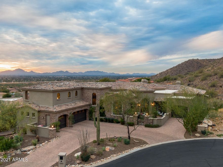 Are you looking for gorgeous mountain and city views from the comfort of your own home? You can check all the boxes with this soft Contemporary-Mediterranean hillside home, located in the popular Ancala Country Club. No expense was spared when designing this estate. From the floor to ceiling, every design detail was carefully thought through, and implemented to ensure the homeowners would want for nothing. Every bedroom is an ensuite, with each one upstairs having its own balcony to enjoy the stunning views, and the downstairs one having a walk-out covered patio to the amazing back yard. The home features a formal living room that opens to the courtyard with mountain views, open family room, formal dining room/breakfast room, bonus room & a stunning eat-in kitchen - all with amazing views from each room! A guest bathroom is not only conveniently located, but is a showcase itself with the custom designed natural stone & iron under-lit vanity. The master bedroom is luxurious, and yet still cozy with its pass-thru fireplace, sitting room and balcony. The walk-in closet features built-ins, along with washer/dryer hookups. The master bathroom has his and hers vanities, an oversized shower and a soaking tub strategically placed to ensure optimal enjoyment of the fireplace and mountain views. Even the laundry room is fully appointed with a large sink and built-in freezer! The outdoor living spaces, from the front courtyard to the backyard and covered patio are the icing on the proverbial cake, with every design feature allowing for mountain and/or city light views. A built-in BBQ & fireplace both add another level of enjoyment to the already well-appointed backyard living space. The uniquely shaped pool and spa allow you to comfortably enjoy starry Arizona nights, gorgeous sunsets and city light views - all from the comfort of your own home. All facts, figures and measurements are approximate, subject to change without notice and not guaranteed by listing agents/brokerage or sellers.