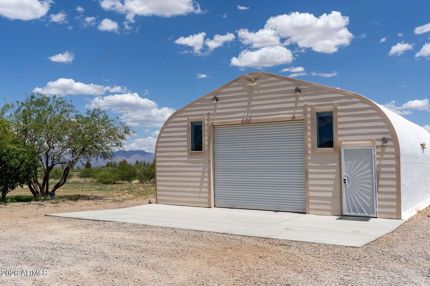 A most unusual home!  This modified Quonset building houses a quality apartment.  Complete kitchen w/quartz counters, electric range, and a beautiful black walnut breakfast bar.  Just off the living area is the utility room w/ washer/dryer and a room sized closet,  A complete bath w/free standing shower. Optimal use of space, this is downsized living at its best w/no sacrifices.  Leading to the loft bedroom is a beautiful hand peeled, finished Alaska Blue Diamond Willow handrail.  From the loft one can see mountain ranges in all directions...beautiful AZ sunrises and watch the moon dance with the stars.  A finished garage and  20 x 20 gazebo complete the home package.  Nestled on five fenced acres, access is via either of two solar gates with controls. Only a short commute to Sierra Vista, Ft. Huachuca, Bisbee and Douglas. And all via paved roads.  Well is shared by four households.  Miles of horse back riding lie just outside the gate...hike the backroads, bird watch..a photographer's pallet.