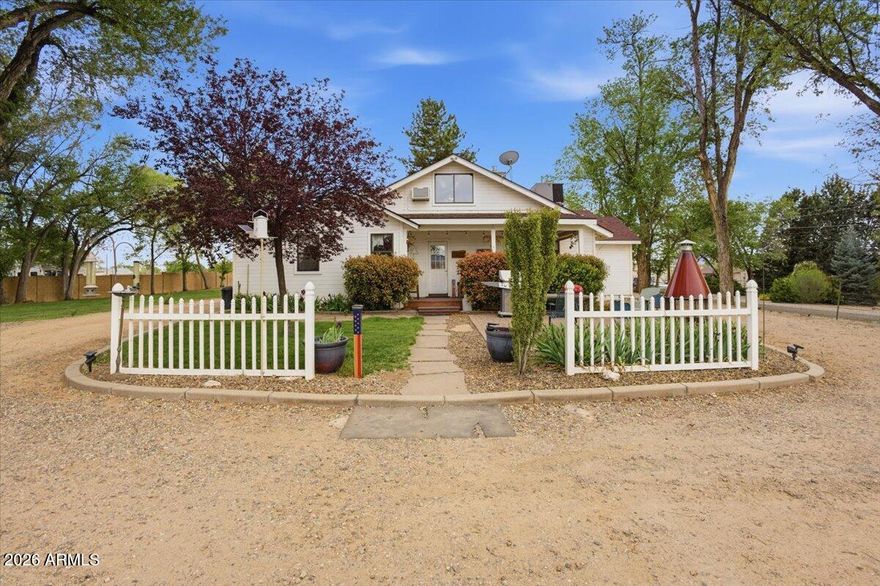 This 1945 Mid-Century Ranch style historic home with a BRAND NEW SEPTIC TANK offers true country living and sits on a hair under an acre, where a quieter rural setting meets everyday functionality. 

The additional AR-5 zoning allowing for agricultural use, including horses and other animals. The interior spans a total of 2,416 square feet, including 2,081 square feet of main living space with a very open floorplan including a spiral staircase leading to a 335 square foot loft filled with natural light. 

The grounds include a detached 2-car garage and a HUGE, detached 1,440 square foot workshop with power and a metal roof, ideal for mechanics, contractors, storage, equipment, or large-scale projects. There are at least a dozen slab parking spaces in addition to the garages between and around the structures. Bring your RV, cars, boats, toys & animals!

The welcoming front porch leads into the home, featuring a fireplace bordered in colorful stone, split-bedroom floor plan, and generously sized rooms throughout, along with beautiful archways reflective of the era.

An open, eat-in country kitchen with the cutest breakfast nook plus a Butler's pantry, features all Kenmore appliances and a large walk-in pantry just off the formal, oversized dining room.

The large primary bedroom suite includes two large walk-in closets and its bathroom includes a Whirlpool tub. Both bathrooms offer dual vanities and a separate toilet room. 

Tasteful paint colors carry throughout the home.

The covered rear patio and 16x8 wood deck provide outdoor living space for relaxing or entertaining. This is the perfect place to view the glorious Arizona sunsets with your favorite beverage, and, is an amazing space to entertain.

AR-5 zoning allows for agricultural use offering potential for additional limited livestock on this parcel.

Leach field replaced approximately 2.5 years ago and water well replaced approximately 6-7 years ago. And, the whole house has a  water filtration system.

Ideally located just minutes from local grocery, shopping, and everyday essentials. Additionally, Prescott is approximately 15-20 minutes away, known for its vibrant downtown, local energy, and year-round events.

Don't miss this standout property offering space, tranquility, function, and flexibility.