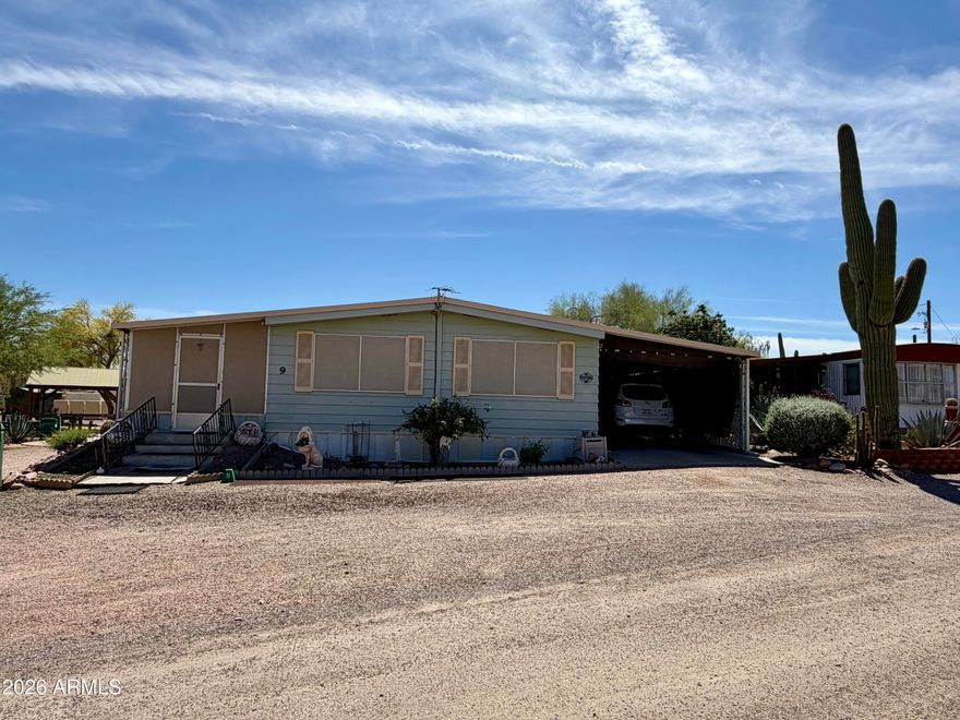 Experience serene desert living with stunning views of the Superstition Mountains from your large screened-in porch in this beautifully maintained doublewide manufactured home. Situated on a low lot rent property within a peaceful, rustic desert community, this home combines comfort, convenience, and affordability with the natural beauty of Arizona's desert landscape.
Inside, you'll find two spacious bedrooms and two full bathrooms, providing comfortable accommodations for family, guests, or a home office. The open-concept living and dining area is bright and inviting, perfect for entertaining or relaxing, and flows seamlessly into a well-equipped kitchen featuring a new refrigerator, ample cabinet space, and generous countertops. Ceiling fans throughout ensure year-round comfort, and a dedicated indoor laundry area adds everyday convenience.
Storage is plentiful with three separate storage sheds and one workshop, ideal for hobbies, projects, or extra storage needs. The attached carport provides sheltered parking, while the low-maintenance desert landscaping keeps the outdoor space looking beautiful without constant upkeep. Step outside onto the expansive screened-in porch to enjoy full-size views of the Superstition Mountains, whether relaxing with your morning coffee, watching evening sunsets, or entertaining friends and family.
This property is thoughtfully designed for practical desert living while offering plenty of versatile spaces. The combination of workshop, multiple storage sheds, mountain views, low lot rent, and rustic surroundings creates a rare opportunity to enjoy the best of Arizona desert life. Move-in ready and full of charm, this home allows you to embrace both indoor comfort and outdoor serenity in a welcoming community.