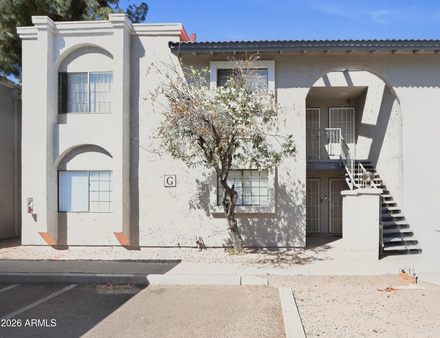 Cozy up to a beautiful fireplace in this bright, inviting condo. The open living area flows to French doors leading to a charming courtyard. Enjoy spacious bedrooms, a private patio, and a light, airy feel throughout. The kitchen offers ample cabinets, a built-in microwave, stackable washer/dryer hookups, and neutral tile flooring. Conveniently located near the 101 and 51, this first-floor unit includes nearby parking. The community features a lovely, spacious pool area. Charming, functional, and move-in ready!