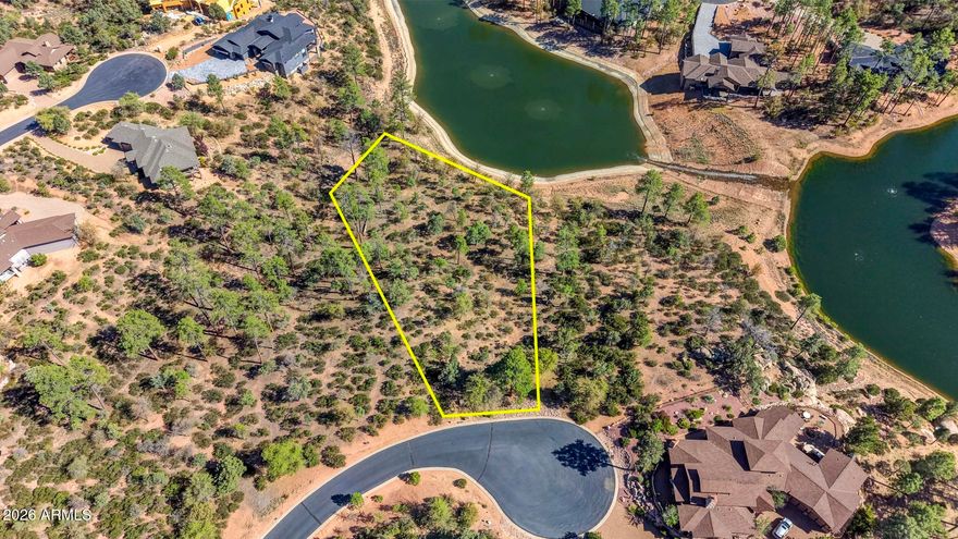 Rare waterfront homesite in Chaparral Pines. This .95-acre property offers majestic Ponderosa pines, lake views, mountain views, and an easy building envelope. Enjoy beautiful lake views to the southeast and scenic views of the mountains. An open space corridor borders the north side, providing additional privacy and a natural wooded setting. The lot was firewise treated in 2025 and has been surveyed and staked. Preliminary plans for a 3,650 sq ft single-level home with a 4-car garage designed by architect Rex Hinshaw will convey. Located in the guard-gated Chaparral Pines community with access to golf, dining, fitness center, pool, Trailhead Park, sport courts, and trails.