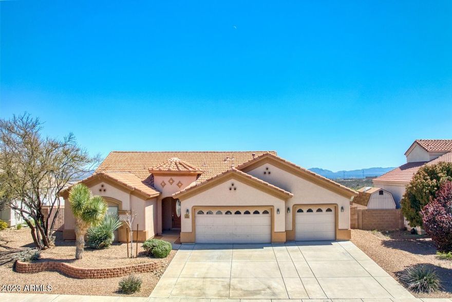 SUN CANYON CUSTOM HOME in CASAS ADOBE.  This Beautiful Laredo Split Floor Plan is Very Open with High Vaulted Ceilings.  Nice Upgrades which include Andersen Windows & Slider, Lighted Niches in Hall, Foyer & Great Room, Two Tone Interior & Exterior Paint, Coffered Ceilings & 50 Gallon Water Heater.  Newly Installed Carpet in Bedrooms & Great Room.  Open Kitchen has Granite Counter Tops and Upgraded Cherry Cabinets with Pull Out Lower Shelves.  Large Breakfast Bar & Dining Area features a Bay Window. Spacious Primary Bedroom features Bay Window. Large Walk-In Closet  and Bathroom has Over-Sized Walk-In Shower & Dual Sinks.  Granite Counter Tops in Both Bathrooms with Cherry Cabinets. Oversized 3 Car Garage, RV Gate and Great Views.  NO HOA Due's. RV's Permitted. Nicely Landscaped.