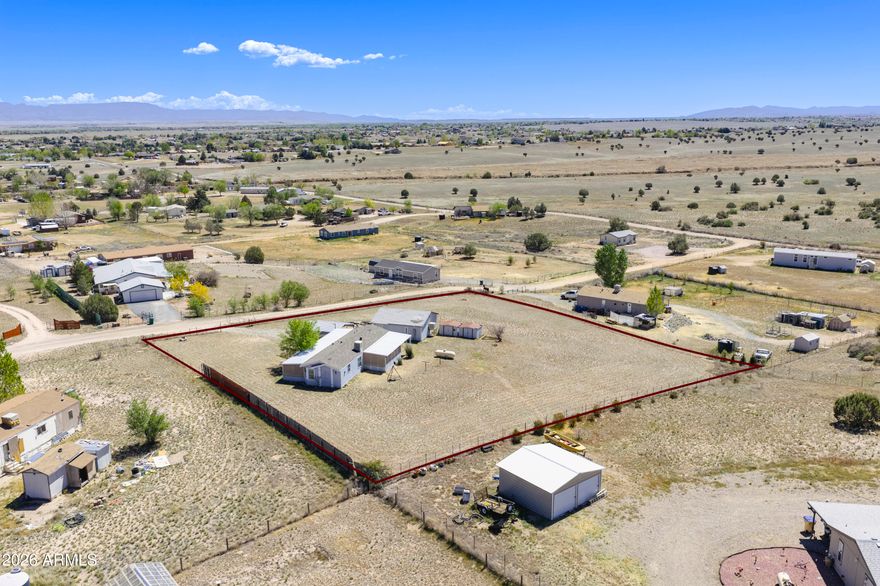 Come to see this 2 bed 2 bath with 2 car garage and carport on 1 + acre. Stay for the views. This Big sky property has amazing views of Granite Mountain, Mingus and the Bradshaw Mountains. The front and back Porches are screened and covered providing additional enjoyable relaxing areas for morning coffee and evening desert. The two bedrooms are good sized and primary has a walk in closet. 3 storage sheds out back with an owned propane tank. ADA ramp from garage, carport area to front porch if needed. The property is fully fenced with solar powered driveway gate. The Owners have taken the few cosmetic repairs needed into consideration of the Listing Price.