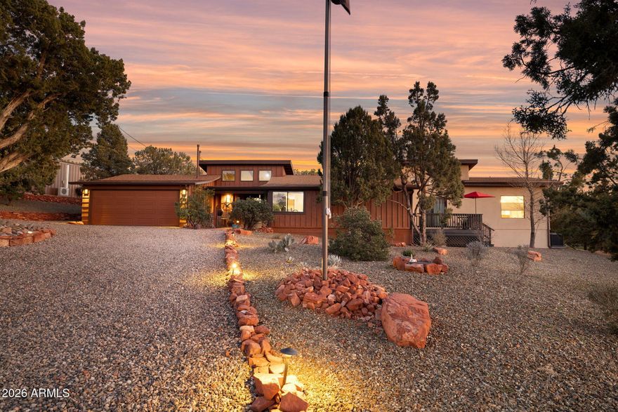 One of a kind Sedona horse property just 15 minutes from Uptown with commanding views of Boynton Canyon and Thunder Mountain. Wide open green pastures, red rock backdrops, and a sense of space that almost never exists this close to town set the tone the moment you arrive.
The ranch-style home is warm and inviting, designed to bring the outdoors in with vaulted ceilings, exposed wood beams, expansive windows, and an easy, natural flow throughout. The living room is anchored by a dramatic river rock fireplace, creating a cozy focal point while framing peaceful pasture and red rock views. The kitchen features granite countertops, stainless steel appliances, and a breakfast bar that opens seamlessly to the main living space perfect for everyday living or entertaining. Multiple patios and outdoor seating areas extend the living space outside, ideal for morning coffee, sunset views, and quiet evenings beneath Sedona's star-filled skies. Mature trees and open land create a serene, park-like setting rarely found in West Sedona.
Built with serious equestrian use in mind, the property has been thoughtfully upgraded throughout. A newly created half acre irrigated grazing pasture, improved fencing and gated access between pastures, and an automatic filtered water system for continuous fresh water. The equestrian facilities include six stalls with new rubber mat flooring, a large round pen with privacy screening and summer shade capabilities, a refreshed arena with new sand and split rail fencing, and a dedicated training and turnout area connected directly to the barn.
The stables itself has been enhanced with a fully built-out tack room complete with lighting, shelving, outlets, and refrigerator, along with a wash sink, misters for summer cooling, and camera surveillance for peace of mind. A sculpted stone walkway and retaining walls connect the pole barn and stables, while expanded trailer parking makes hauling and access effortless. 
Recent home upgrades include seamless gutters with new downspouts, a new heating and cooling system serving the primary suite and additional living areas, freshly painted front and rear decks, updated privacy fencing, and new driveway and entry gate posts. The pole barn has also been upgraded with a heavy-duty automatic garage door opener.
Conveniently located near hiking and riding trails, Seven Canyons Golf Club, shopping, and dining, this property offers the best of both worldsspace, privacy, and true equestrian functionality without sacrificing access to everything West Sedona has to offer.
This is a rare opportunity to own a fully improved horse property with views, land, and lifestyle in one of Sedona's most desirable locations.
