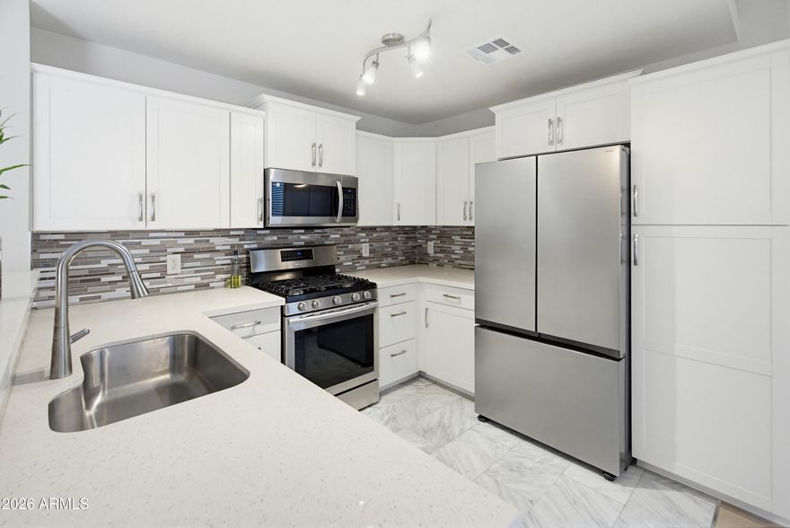 BUYER TO RECEIVE UP TO 3% CONCESSIONS WITH A FULL PRICE OFFER. Welcome Home -- Be greeted by pristine updates throughout this 2-bed, 2-bath, 2-car garage home. Immaculately maintained and MOVE-IN READY. The kitchen highlights beautiful white quartz countertops, elegant cabinetry, stainless-steel appliances, and a BRAND-NEW Samsung refrigerator. This spacious corner lot features a NEWER A/C (2024), Newer water heater (2021), BRAND-NEW flooring and baseboards throughout the kitchen, living room and bedrooms, blinds on all vinyl windows, hallway accent wall, all appliances included, a primary bedroom offering a separate exit through the backyard covered patio, and a NEWLY carpeted primary walk-in closet. Here you will have a low maintenance front and backyard, equipped with two sheds for additional storage and added privacy with no neighbors directly behind you. Conveniently located just minutes from Westgate Entertainment District, and easy access to Loop 101 and Interstate 10. This home has it all and is ready to be yours!