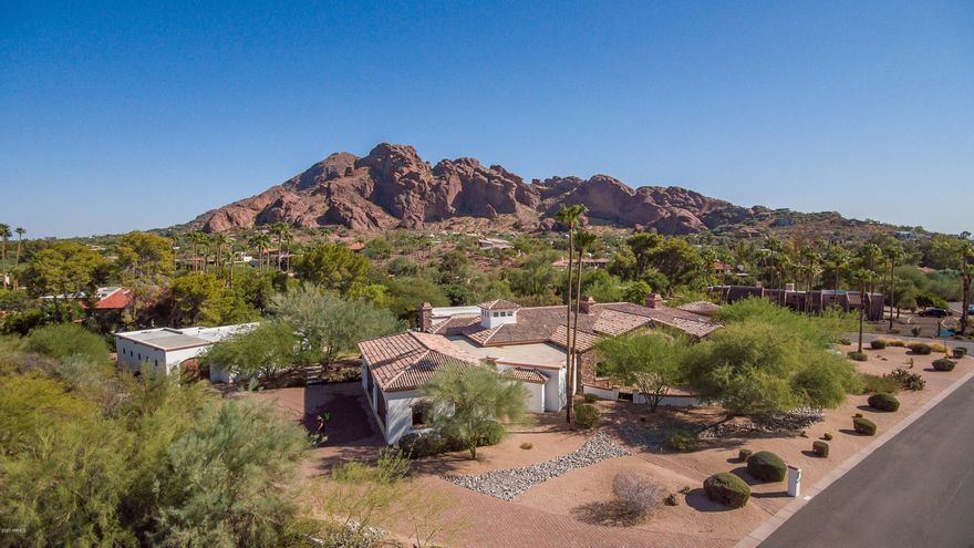 Views Views Views Welcome home to this amazing single level custom built estate nestled 600ft from majestic Camelback Mt.  New construction in 2008 includes large chefs kitchen with double islands, two prep sinks, commercial size refrigerator, all Electrolux & Thermador appliances.  Do yoga or workout in your private bonus 1000sf gym space that can be used as a flex room for the hobby, boating, or car enthusiast.  The 4,746sf main house includes 4 bedrooms, home theater, and grand owners retreat with 16ft high  rotunda master bath shower/tub view with mountain views  .  Private 1,122sf detached guest house adds 2 more bedrooms for guests or a great private art or workspace.  Extra-large 4 car garage with Tesla charging station.  Outside multiple gas fire features with large covered and uncovered patio space for entertaining large groups.  Looking for an even better view?  Go upstairs to the view deck to relax and take in the view-set up for hot tub placement with water and power.  Energy efficient home with spray foam insulation including sound proofing around home theater