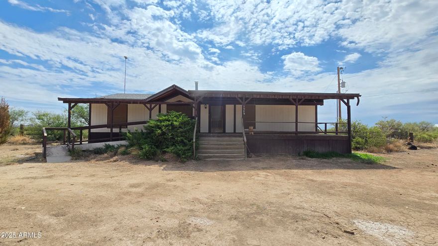 3 bedroom, 2 bathroom manufactured home situated on approx. 65 acres across two parcels. Zoned R-36 and may be divided. Interior offers a split bedroom floor plan with master separate from additional rooms, plus both a living room and family room. Exterior features include a barn with 3 stalls, fenced pen for horses, cattle, goats, or poultry, and ample acreage for multiple uses. New AC installed in 2024. Shared driveway and shared well. Panoramic mountain and countryside views with potential to update and customize.