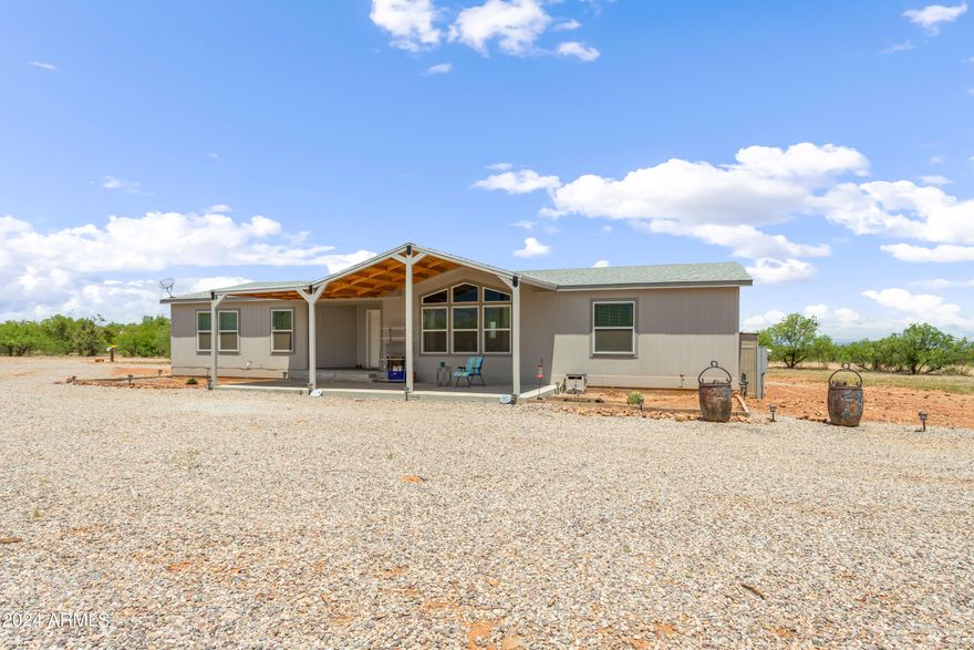 Newer manufactured home (2020) sitting on just over 1 acre corner of San Pedro Drive and Glisch. Spacious living area, dining and kitchen for all your entertaining and enjoyment. The kitchen has an abundance of cabinets and counter space, island and walk-in pantry. Home is a split floor plan with master bedroom on the opposite side of the house from the other 2 bedrooms. In the large master bedroom is a great ensuite and huge walk-in closet with a windrow and built ins. Outside a covered patio has been added to allow for amazing views of our mountains. Storage shed on the property will convey with the property. New roof on the home has a warranty that will transfer to the new owners. This house has to be seen to appreciate.