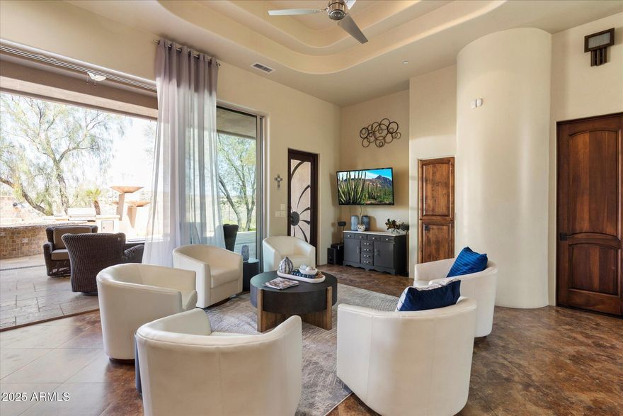 The home is appraised at $3,100,000, presenting an exceptional value opportunity. This 7884 sq-foot custom estate commands sweeping panoramic views of multiple Arizona mountain ranges, including Four Peaks and the iconic Fountain Hills Fountain. Designed for refined living and large-scale entertaining, the resort-style outdoor living space features an infinity-edge pool and spa, sports court, fire pits, built-in BBQ and an expansive 1,200-square-foot rooftop observation deck ideal for sunset and city-light views. A dramatic iron-and-glass entry opens to formal living and dining rooms with uninterrupted view corridors. The gourmet chef's kitchen offers Sub-Zero refrigerator and freezer, dining rooms with uninterrupted view corridors. The gourmet chef's kitchen offers Sub-Zero refrigerator and freezer, Miele built-in coffee system, dual dishwashers and an oversized walk-in pantry, flowing seamlessly into the family room and patio for true indoor-outdoor living. A private guest suite with separate entrance and kitchenette is ideal for multigenerational living or extended stays. The primary retreat includes a fireplace, sitting area, office, dual custom closets and spa-style bath. The lower level features two ensuite bedrooms with walk-out access, a full bar, theater or bonus room and abundant storage. Three-car garage with climate-controlled bay completes this extraordinary luxury residence with world-class views.