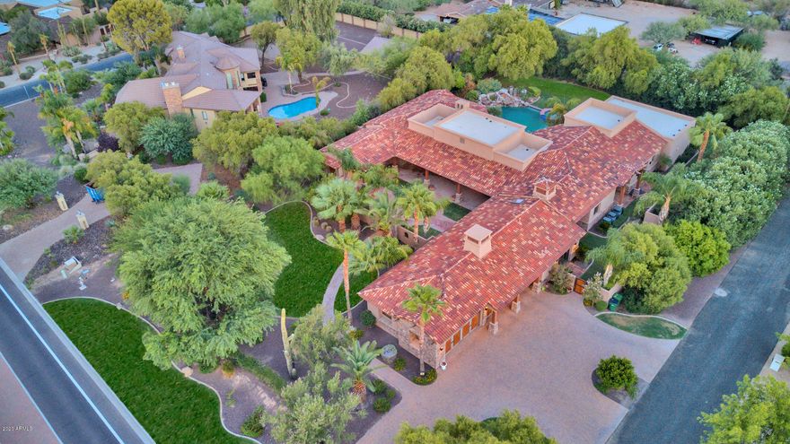 Offering an authentic circular front court yard, casita, 5-bedrooms, 4.5-baths split floor plan. A perfect combination of entertaining spaces, detailed finishes and desirable location. Situated on an oversized lot, features include custom woodwork throughout, sprawling gourmet kitchen, theatre room, and climate-controlled wine cellar. Expansive outdoor spaces flow seamlessly through over-sized retractable walls to a 900 sqft covered patio boasting built in BBQ and fireplace, resort like pool/spa/water feature, and a separate entrance for the guest Casita. True classic Paradise Valley living with close proximity to all nearby amenities. See MOTION VIDEO