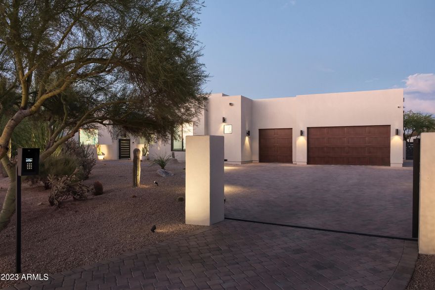 Welcome to almost new construction on 1.5+ acres in N Scottsdale! A private gate opens to a massive driveway where pavers in a herringbone pattern lead to an oversized 5-car tandem air-conditioned garage. You enter the home through a private courtyard that offers access to your 486 sq ft casita. The main house has a bonus den and an office with a custom studio glass wall. Indulge your inner chef in the state-of-the-art kitchen, complete with Sub-Zero appliances along with a double pantry. The resort-style backyard is a true haven, boasting a bbq and hibachi area nestled under a custom pergola.  The star of the backyard is the elevated 786 sq ft Pool house and gas heated pool/spa.  This east/west exposure is bordered by NAOS to the north which offers spectacular views of nearby mountains.