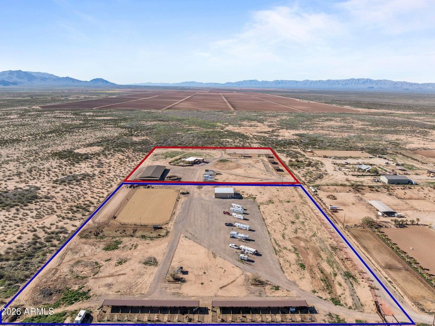 This fully permitted equestrian estate offers an exceptional setup designed for functionality, privacy, and serious horse use. GravFeaturing two separate gated entryways with attractive landscaping, direct access to Arizona Trust land, & thoughtfully designed improvements throughout the property includes 3 arenas for team roping, breakaway &barrel racing each with hauled-in sand & a lighted arena equipped with remote-controlled solar lighting. Enhancements include 2 Priefert roping chutes hot walker & 3 steer pens with automatic waters. The horse facilities are extensive, featuring (8) 60 x 40 covered pens and (4) 60 x 40 additional uncovered pens with solar lighting, automatic waters & feeders a large barn  (approx. 14,000 sq ft) with (10) 15' x 30' stalls, 2 tack rooms (1 with a bathroom large covered hangar-style structure providing ample shaded space for saddling. Additional improvements include (20) 12' x 20' covered pens & (10) 10 by 10 uncovered pens, for a total of 54 pens & stalls across the property. Additional amenities include a 2,400 square foot shop with a 1000 sq ft hay storage located on the west side of the shop, private well with approximately 3,000 gallons of storage & 400-amp electrical service (200 + 200). The shop features approximately 800 square feet of guest quarters complete with a bedroom, bathroom, walk-in closet, laundry room, pantry, all-electric kitchen, and extra insulation. RV accommodations include 10 50-amp and 1 30 amp RV hookups, plus an additional 50-amp hookup at the house power panel, along with a designated BBQ area for guests. Mature orange, lemon, and lime trees.