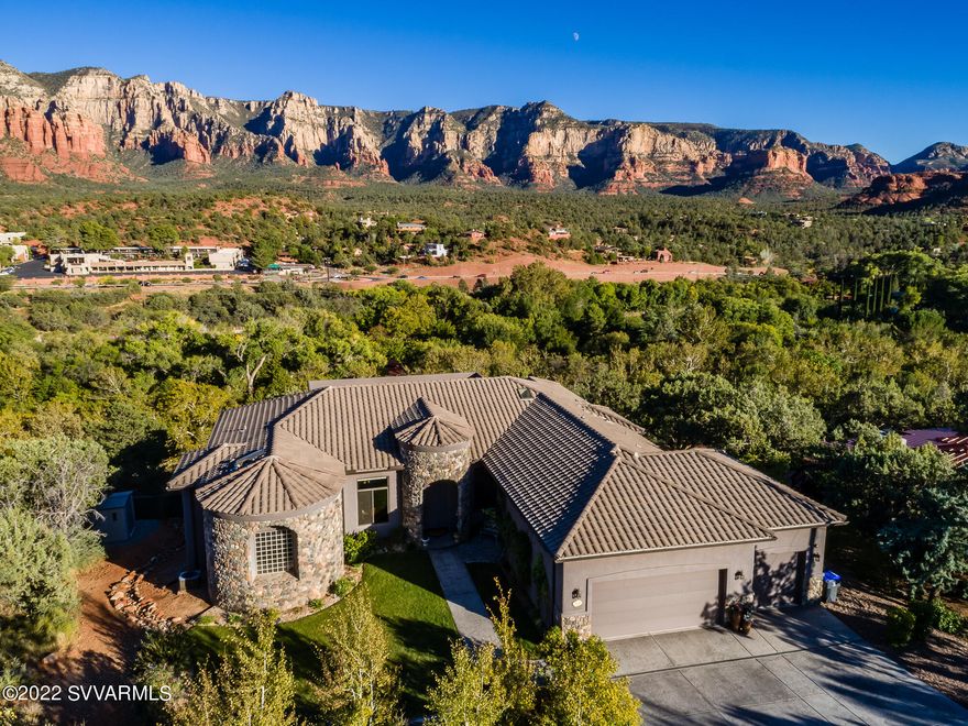 One of the most spectacular luxury homes in Sedona w/ breathtaking & panoramic red rock views! Beautiful single level estate w/ exquisite finishes & upscale appointments. An open & spacious design brought to fruition w/ meticulous attention to detail & completed in 2018(C of O attached). Soaring 12 ft ceilings & dramatic view windows. Incredible chef's kitchen w/ Miele, Sub zero & Wolfe appliances. Luxury & spacious primary suite w/ views, deck, massive custom closets & adjoining sumptuous bath w/ steam shower & jetted spa. Three en-suite bedrooms.  Enjoy the sounds & views of Oak Creek from the  54 foot deck w/ outdoor fireplace. Available turn key & completely furnished. Spa & 3 car garage. Successful short term rental with Sedona.org. No HOA. OWC financing. SEE ADDITIONAL REMARKS. Special Features

"	Beautiful and inviting arched entry and rock exterior.
"	Appealing exterior features a three- car garage with 12 foot ceilings and ample storage.
"	Fully, professionally landscaped and irrigated; including rainwater recapture tank and organic garden.
"	Zen garden and Pergola graced by dual water features.
"	Backyard Spa and patio area enjoying stunning red rock views.
"	Putting green, bocce court and bean bag toss areas in addition.
"	Stargazing and sweeping views from the 54 foot deck enhanced by an outdoor fireplace, dining and barbecue areas.
"	Separate, lower level recreation room offering gaming area, shuffle board, lounging area and refrigerator.
"	Custom Travertine, cross cut, plank stone flooring.
"	Melting Point hand-blown and custom light fixtures.
"	Architectural design boasting soaring, twelve foot ceilings, art niches, skylights and recessed lighting.
"       Chef's custom kitchen features Miele ovens and warming drawer, Wolfe 6 burner range, Sub Zero built-in Cafe-style refrigerator and freezer with interior cold water purifier and dispenser. Matching cabinetry on Asko dishwasher and refrigerator. Great island with additional prep sink and seating. Generous walk-in pantry.
"	Faux painting, electronic Luminette window treatments, separate sitting area and coffered ceiling in expansive primary suite.
"	Massive, walk-in custom closets and extra storage with secret jewelry closet in primary suite.
"	Spacious primary suite bathroom includes separate vanities, hand hammered copper sinks, gorgeous granite, jetted spa tub, steam shower with bench, skylight, separate television and private commode room.
"	A total of three en-suite bedrooms of generous proportions. Adjoining bathrooms are appointed with custom cabinetry and finishes.
"	Professionally designed and installed custom, surround sound and outdoor speaker system. A total of six television monitors and systems are included.
"	Convenient  laundry room includes extra large, top of the line washer and dryer, granite, ample cabinetry and storage plus hanging and folding areas.
"	Bonus storage shed plus under house, walk-in storage area.