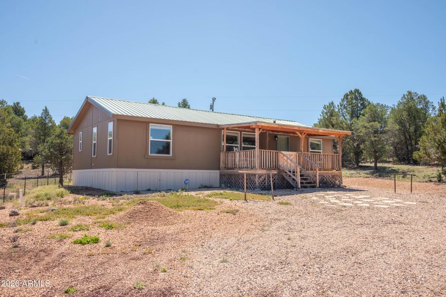 This move-in ready like new Fully Furnished home combines a 2018 manufactured home with a spacious one-acre lot, offering modern indoor living and expansive outdoor freedom with no HOA restrictions. Turnkey 3-Bed, 2-Bath on 1 Acre. Embrace the perfect balance of modern comfort and rural freedom. This  home features a beautifully maintained  open-concept floor plan.  With a large front porch for entertaining or watching spectacular sunsets. A newer Air conditioning and a Metal Roof. The front of this home has rock landscaping and a cinder circular driveway. A great Summer home or vacation rental.