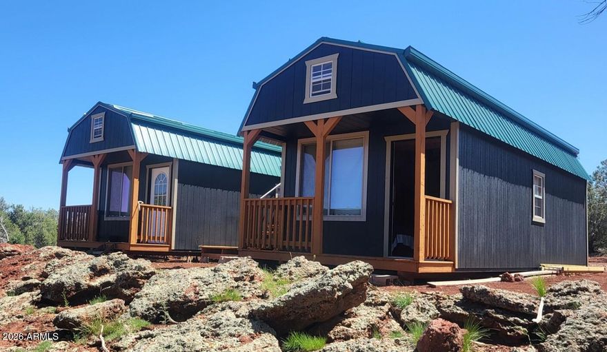 Head of the Canyon with big trees and a ton of development all ready in place. Most all building materials stored and will transfer with the sale. 864 sqft Cabin with144 sqft viewing deck. Pre wired and pre-plumbed. Views of San Francisco Peaks. Abuts State Trust 640 Acres. 38 Ft. Montana RV with 4 slides. Covered with a steel shade and rain cover. All in Excellent Condition. 32' X 20' High Quality Military Garage. Included with sale the Massey Ferguson Tractor. This 40 acre Canyon property is in the middle of Elk & Deer country, hunt unit 10. Surrounded by rock bluffs and very cool rock out cropping's. Nice watersheds. Most everything go's with sale. To much stuff to list. The 80 foot rock bluff on the north side is all part of the property.