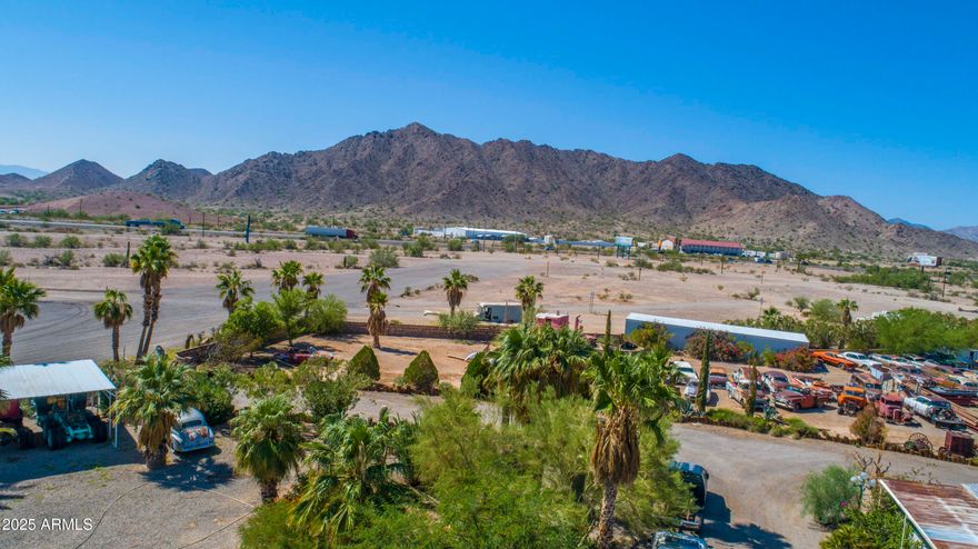 Expansive 34+ Acre Opportunity in Quartzsite, AZ. Visibility from Interstate 10 and includes a Runway, Warehouses, Residences & Hangars — Endless Commercial Potential !! This multi-parcel offering has two larger adjoining parcels and one parcel perfect for signage closer to I-10. This 34 acres is C2 Zoned with a private well, two septics, power and a city maintained road. Location is not only near I-10, but also 13 miles from the border of California, and an easy 2 hour drive from the central Phoenix area. Excellent access and visibility for a wide range of uses including RV parks, Truck parks, storage facilities, warehouse operations, vendor villages, entertainment venues, and other commercial concepts that benefit from high-traffic corridors. Property Highlights Three parcels totaling over 34 acres Power on Site Well with new pump. Two septic systems Visibility from Interstate 10 Easy access Borders BLM land Seller will consider Owner Financing with 50%+ Previous car sales business can be removed from the site within a negotiated period following close of escrow. Improvements & Structures Include: Private runway: approx. 1,400+ ft Shop Buildings: 24,604 sq ft of warehouse, workshop, or storage space Hangars: 3,782 sq ft Additional Storage: shipping containers, sheds, overhangs, and shade structures Manufactured Home: 1,372 sq ft Site-Built Wood Frame House: 1,536 sq ft Detached Garage: 960 sq ft These structures provide multiple living, rental, or workspace options, as well as flexibility for caretaker housing or on-site management.