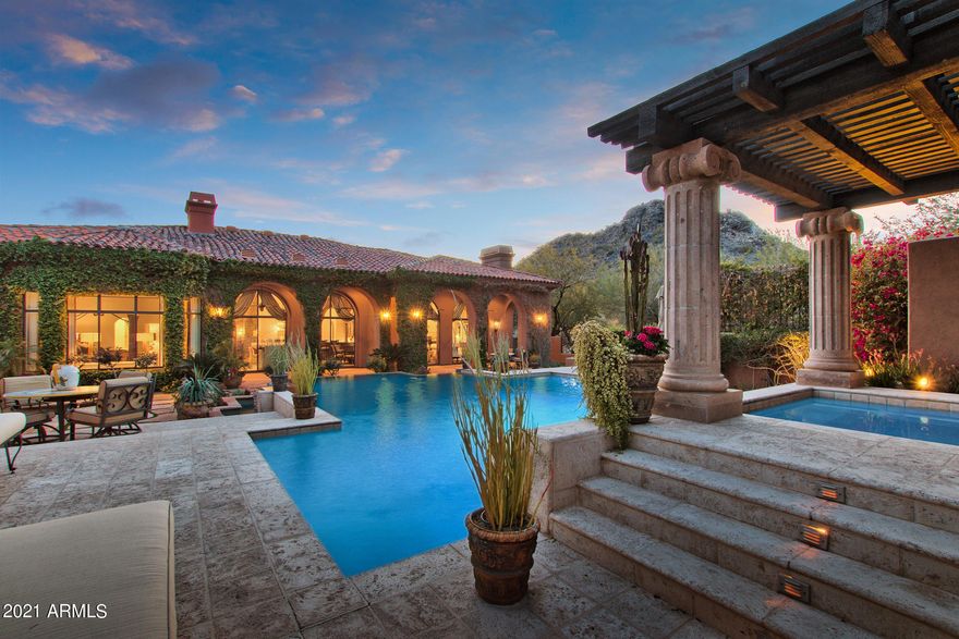 WELCOME HOME! THIS IS AN ENTERTAINERS DREAM HOME WITH
EXPANSIVE INDOOR/OUTDOOR LIVING. THIS STUNNING CUSTOM HOME
WHICH WAS FEATURED IN HOME AND GARDEN MAGAZINE, HAS BEEN
METICULOUSLY RENOVATED BY AWARD WINNING OWNER/DESIGNER AND
IS SITUATED ON 1.1 ACRE MTN. PRESERVE LOT THAT ASSURES PRIVACY
AND IS LOCATED IN THE RETREAT AT ONE HUNDRED HILLS, A GATE
GUARDED COMMUNITY. THIS PROPERTY IS UP AGAINST THE BACKDROP
OF THE MCDOWELL SONORAN PRESERVE. YOU WILL LOVE THE CITY
LIGHTS AND MOUNTAIN VIEWS THIS LOT OFFERS. THE RESORT-STYLE
BACK YARD FEATURES AN AWARD WINNING NEGATIVE EDGE POOL WITH
ITS NATIVE MOUNTAIN ROCK FACADE THAT FLOWS FORWARD ENVELOPING
YOU WHEN YOU WALK IN THE FRONT DOOR. SURROUNDED BY LUSH
LANDSCAPING, BBQ/OUTDOOR BAR WITH DUAL SIDED FIREPLACE
ATTACHED TO THE FULL CASIT WITH ROOFTOP VIEW DECK!!! THE MAIN HOUSE BOASTS THE HIGHLY SOUGHT AFTER OPEN FLOOR PLAN W MULTI ENTERTAINING / SITTING AREAS WITH 2 STONE FP'S, PLUS A ONE-OF-A KIND CUSTOM BAR BRILLIANTLY BUILT IN THE CENTER OF THE HOME 
FOR HOLIDAY DINING AND FABULOUS ENTERTAINING. THE GOURMET KITCHEN WITH ALL THE UPGRADES COMES W/ A 2ND CUSTOM IRON/GLASS STONE TOP HUTCH THAT MATCHES THE 2 CHANDELIERS!! PLUS FEATURES A HUGE WALK IN PANTRY/CRAFT AREA!! HEAR THE SOUNDS OF WATER IN THE ELEGANT MASTER RETREAT W SITTING AREA AND DRESSING CIRCLE W/ART NICHES AS ONE ENTERS THE DREAM CLOSET!! THE REMODELED MASTER BATH FEATURES AWARD WINNER ARTISTIC TILE WALL IN ETCHED PEONY, HIGH-END SANTEC FAUCETS IN BRUSHED GOLD AND MATCHING CUSTOM HARDWARE. THERE IS A BONUS/MEDIA ROOM WITH CUSTOM FLAT SCREEN MEDIA CENTER INCLUDED THAT OVERLOOKS THE FRONT COURTYARD THAT IS OFF OF THE TWO GUEST ENSUITE BEDROOMS. THE OFFICE/DEN/LIBRARY WITH CITY VIEWS HAS DIRECT ACCESS TO THE FRONT COURTYARD,INCLUDED WITH BUILT-IN CUSTOM OFFICE FURNITURE W/FILING, PRINTING AND MEDIA STORAGE PLUS A HOME NETWORK CLOSET WITH AMPLE STORAGE . MOST  FURNISHINGS AVAILABLE THROUGH A SEPARATE BILL OF SALE. SEE A COMPLETE LIST OF HOME'S AMENITIES IN DOCUMENTS SECTION.