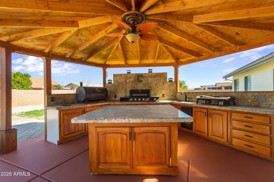 ENTERTAINMENT HAVEN! This 3 bdrm, 2 bth home includes 3 XTRA rooms! Bonus 1st room. Add a wardrobe for an additional bdrm & make it 4! The other 2 can be for multi-use. Cozy family room w/ fireplace & formal dining. Open concept kitchen & living room also perfect for entertaining. Landscaped & irrigated front & large back yard. Beautiful gazebo covering a full outdoor kitchen w/ wall area for a flat screen TV. Ideal place for entertainment! Large spa & bricked in patio area add to the entertainer's dream. Dress it up w/ a nice firepit & furnishings to your taste. And yes, there is a place for your RV! Drive it through the RV gate & park it next to the 2 multi-use storage sheds. Come out & bring your imagination, bring an offer, and bring your guests!