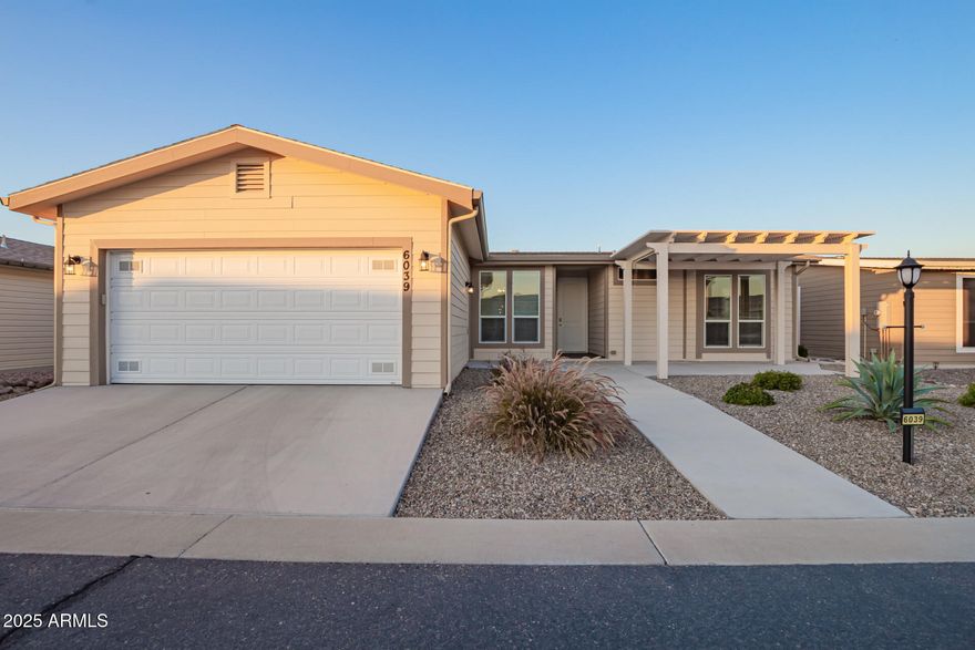 One of the newest homes in Dolce Vita! Built in 2021, this rare 3 bedroom, 2 bath home with a 2 car garage offers modern comfort in one of Mesa's premier guard gated 55+ communities. The upgraded kitchen features sleek quartz countertops, a brand new refrigerator and stove, and bright contemporary finishes that create a fresh, inviting space for everyday living and entertaining. Enjoy relaxing outdoors under the newly added front pergola or unwind in the spacious Arizona room designed for year round enjoyment. Why buy new and pay nearly $10,000 in sales tax when you can own this upgraded, move in ready home today? Residents of Dolce Vita enjoy a 33,000 sq ft clubhouse, resort style pool, fitness center, pickleball courts, and a vibrant calendar of social activities. Mediterranean-style clubhouse with a ballroom, fitness center, library, billiards, card and craft rooms, plus a heated pool, two spas, tennis and pickleball courts, and a full calendar of social activities.