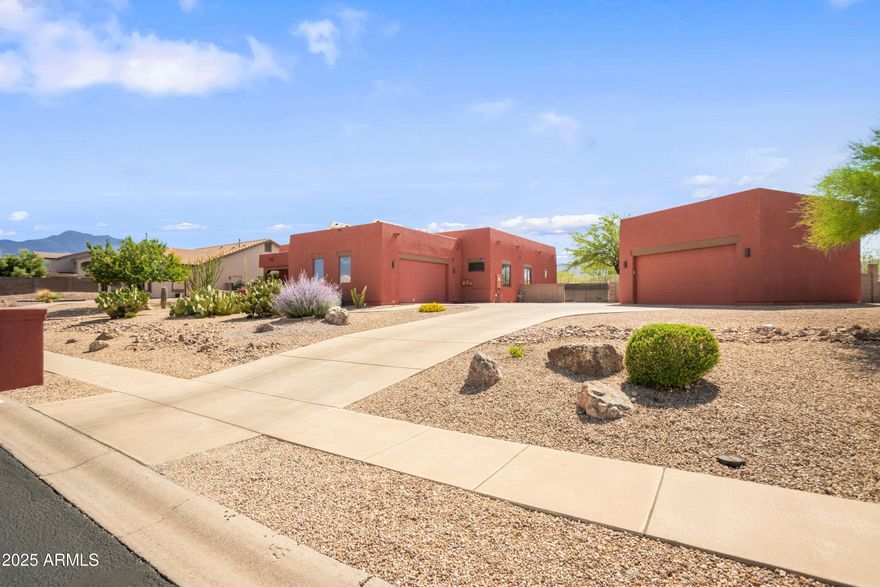 Discover this elegant custom Walston home in Sierra Vista: a 4 bedroom, 3 bath spanning 2,819 sqft including a 250 sqft heated & cooled workshop/gallery converted from the back portion of the detached garage. The home features formal living and dining areas, a great room with fireplace and custom blinds, and an updated kitchen with stainless steel appliances, abundant cabinetry, and quartz counters. Vaulted ceilings and hardwood-style ''Vegas'' floors flow throughout, complemented by dual-pane windows for efficiency and a brand new hot water heater. Recent updates include fresh interior/exterior paint, upgraded landscaping, and modern lighting. Outside, resort-style, low-maintenance landscaping reveals panoramic mountain and city-light views.