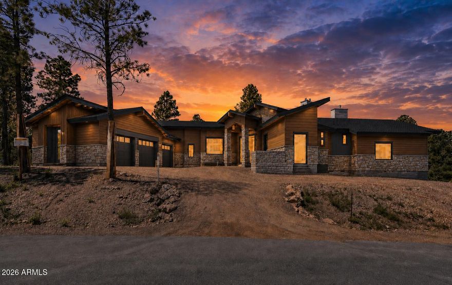 CORNER LOT ON CLUBHOUSE RD | ELEVATED PINE CANYON POSITION | MODERN CONTEMPORARY DESIGN | 15-FOOT CEILINGS Positioned on a prominent corner lot in Pine Canyon, this custom contemporary home sits above surrounding properties with a commanding presence rarely found in the community. Located on Clubhouse Rd in one of Flagstaff's most recognized golf course subdivisions, the home combines modern architecture with a setting surrounded by mature pine trees. The open layout features 15-foot ceilings, expansive living spaces, and a split floor plan designed for both privacy and functionality. A 3-car garage adds flexibility for vehicles, storage, or gear. Planned interior finishes include white oak cabinetry, white oak flooring, and Taj Mahal surfaces for a clean, warm modern aesthetic. The elevated homesite creates a strong sense of separation and scale while maintaining close access to Pine Canyon amenities, golf, dining, and trails. Currently under construction, offering the opportunity to secure a highly anticipated modern build in one of Flagstaff's most sought-after communities.