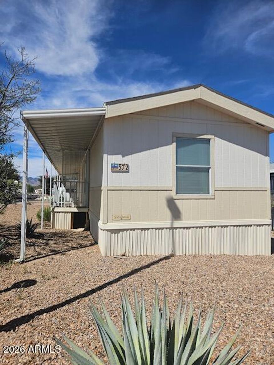 2 bedroom, 1 1/2 bath home with an additional room added not included in square footage. Home is in a gated community with indoor and outdoor pools. 2 club houses, Pickleball, dog park, and many other amenities. Located close to town, hospital and shopping. Home is a fixer upper. Lot rent of $498.00 does include water, trash and sewer.