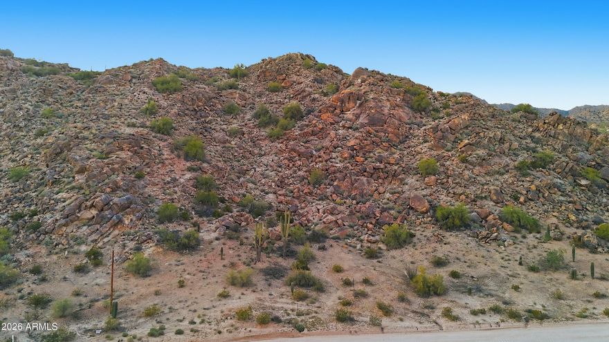 HIKE your OWN MOUNTAIN as high mountain rocks accent your BACK YARD.  GORGEOUS VIEWS  for MILES in this very PRIVATE area among MILLION DOLLAR  custom homes just a block from paved roads.  Great LOCATION within walking distance of NORTH MOUNTAIN PARK'S scenic trails, just five minutes from I-10, and 35 minutes to south Chandler. The building site on the south east corner AWAITS YOUR DREAM HOME.