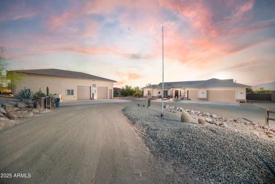 Calling ALL car enthusiasts! On large1.25-acre lot sits a 38,000+ cf custom block 
construction multi-car garage, with incredible Superstition Mountain views. This RARE gem is a dream for all car buffs, entertainers, and more!  Bring all your toys -there's room as it is designed to also store a 42' MotorCoach. Fully insulated and air-conditioned with RV doors, air compressor lines, car lift, bathroom, ample storage. Ideal for all your projects and toys. You can't build this for the price! 
Move in ready custom 3042 sqft, 4 bed, 3 bath beautiful home with its own 3-car garage, features 10 ft soaring ceilings, 20-inch tile, gourmet kitchen with granite, and spacious island--perfect for entertaining overlooking a full length covered back patio. Energy 
efficient Integra  block home, R30 insulation in walls and R38 in attic. Step outside to enjoy the serene surroundings and plenty of space for outdoor activities, whether it's relaxing under the stars or hosting gatherings. Private block fencing on 3 sides, desert landscaped in the rear with plenty of room for your dream pool. Discover peaceful living with stunning Superstition Mountain views at your doorstep. This property blends natural beauty with comfort, privacy, car/toy storage and sweeping views! Just off a paved road with postcard sunrises and sunsets.  Don't miss your chance to make it yours!