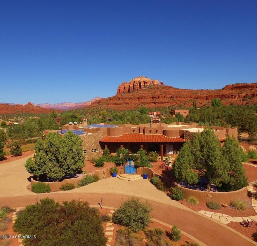 Against the timeless grandeur of Cathedral Rock, this extraordinary gated estate rests on 2.47 acres of serene desert beauty. Every element of the 4,370-square-foot residence is thoughtfully designed to honor its surroundings--oversized en-suite bedrooms, refined finishes, and spaces that flow effortlessly from indoors to out. Whether hosting elegant gatherings or savoring quiet evenings by the fire, the home's expansive patios provide a front-row seat to sunsets that paint Cathedral Rock in deep, luminous hues, creating a setting that is as rare as it is unforgettable.
• Private, natural setting in a gated community (11 lots, rare min. 2 acres)
• Exquisite custom details and art throughout
(see supplement) " Kitchen - Egyptian granite counters, hammered copper farm sink, custom cabinets, Viking appliances
" Kiva fireplaces
" Master Suite and Bath one of a kind
" Guest suites outstanding w/walk in closets, elegant baths
" Whole house water filtration system
" Solar flat installed panels, commercial rated roof
" R 24 walls, R 32 ceiling insulation with closed cell foam insulation which is pest impermeable