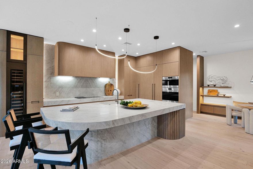 Modern Splendor Masterpiece created by Anita Lang and IMI Designs  located in the heart of Chandler, this home is truly one of a kind. Complete renovation from the ground up just completed with only the best custom materials and finishes used throughout. This home was built with only true luxury in mind and caters to both modern design as well as classic architecture. Custom everything including: cabinetry, lighting fixtures, plumbing fixtrues, flooring, countertops, windows and doors, accent lighting, built in appliance package, wall treatments, front door, exterior stone and so much more. The gourmet kitchen includes hidden compartments, drop down spice racks, massive island with popup outlets, huge pantry with slide outs, grand oversize countertops and backlighting. Living room has collapsing sliding doors that provide true indoor/outdoor living. Master suite boasts custom wall treatments, natural lighting throughout via custom floor to ceiling glass as well as accent lighting. All bedrooms are ensuites and include custom bathrooms specific to each. Lighting package throughout the home is amazing and includes multiple selections/moods. The backyard is a true oasis and includes private 6 hole putting green, gorgeous pool with slide, water and fire features, sunken ramada with swim up bar, fireplace and full kitchen, as well as lush mature landscaping throghout. Nothing was overlooked on this home and it is truly a spectacular one of a kind home!