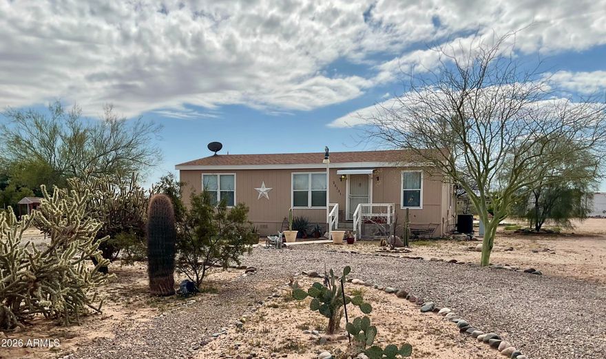Escape the HOA and enjoy wide-open Arizona living! Set on over 1 acre of beautiful desert land with breathtaking azure skies and unforgettable sunsets. Inside you'll find an inviting 3-bedroom, 2-bathroom split floor plan plus a massive 500+sq ft. bonus room--perfect for a game room, workshop or home office. The property includes 3 Conex-style storage containers and plenty of space for RVs, horses, ATVs, pets, and toys. Explore miles of nearby BLM land. Move-in ready! Recent upgrades include: New carpet, fresh paint, new A/C (2022) and a new roof on the bonus room (2023). Located in a great neighborhood with a shared well and low-maintenance landscaping. Conveniently located: 0.4 miles south of Patton Rd and just 7 miles from Grand Ave (US 60) Discover the beauty of the Wittmann lifestyle.