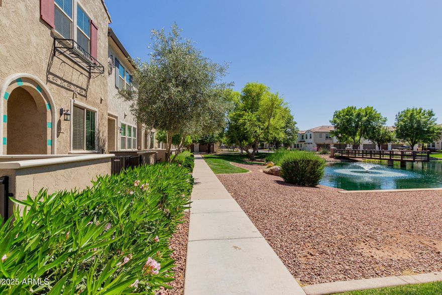 Don't miss this rare opportunity to own one of the best-located homes in the neighborhood! Perfectly positioned with lake views and just steps from the community pool. Features include a tandem two-car garage with extra parking nearby, elegant tile flooring, quartz countertops, stainless steel appliances, and rich espresso cabinets. The primary suite offers a spacious walk-in closet and sleek walk-in shower. Close to San Tan Village's premier shopping, dining, and entertainment.