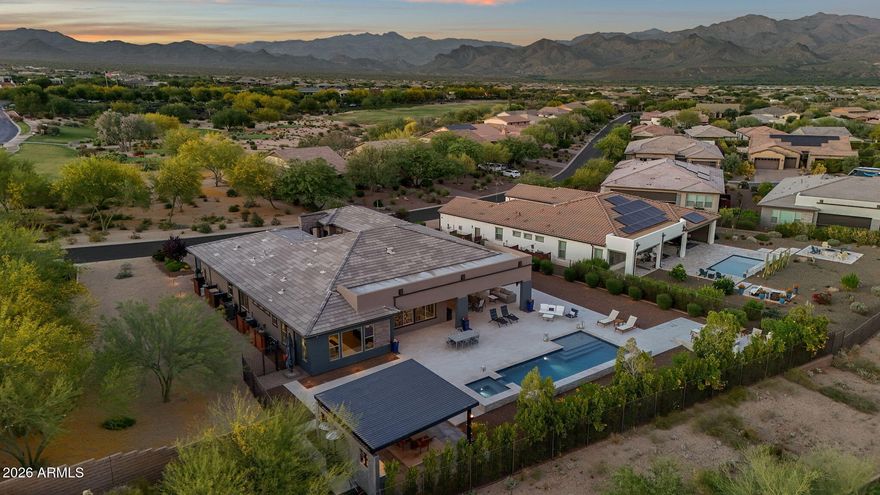 Guard gated, modern desert luxury with attached casita in Rio Verde (just minutes from nearby, bordering Scottsdale), located in Trilogy at Verde River Golf & Social Club. This single-level Dorado model offers 3 bedrooms, 3.5 bathrooms, + a separate office, + a bonus room off the primary bedroom, with 3,480 sq ft on a rare ~1/3-acre lot!! The owners spent several hundred thousand dollars in backyard upgrades alone including 3,500 sq ft of artistic pavers, luxurious pool & spa, huge ramada with outdoor BBQ kitchen, and raised fire pit sitting area to take advantage of the FOUR PEAKS mountain views. Also, the house is pushed far to the west side of the lot allowing for a large side yard and is the only lot with an HOA approved 10' side gate. This lot is ELEVATED and very PRIVATE, as you can't see your neighbors & they can't see you. Situated on a north/south exposure lot bordering a common area, the home features a clean contemporary exterior, paver driveway, and desert landscaping with some natural grass in the backyard.  Inside, an open-concept great room floor plan is highlighted by 12+ flat ceilings, no interior steps, expansive ENERGY STAR qualified low-emissivity windows, and abundant natural light. The chef's kitchen includes a large island with seating, custom cabinetry, LEATHERED granite counters, built-in appliances, flowing seamlessly into the dining area and great room. The primary suite offers a spacious retreat with direct outdoor access. The attached casita includes a private bedroom, full bathroom, sitting area, and kitchenette, ideal for guests, multi-generational living, or flexible use. An additional den/office offers a dedicated workspace or flex room. Located within a gated golf community with access to biking and walking paths, clubhouse, community spa and heated spa, tennis courts, pickleball, workout facility, and concierge services. Nearby access to Tonto National Forest (1.3 miles), Needle Rock Recreation Area (4.6 miles), and McDowell Mountain Regional Park (8.4 miles) offers hiking, biking, and outdoor recreation, with additional golf opportunities at Trilogy Golf Club at Verde River (0.1 miles). Also, within reach of North Scottsdale dining, shopping, and entertainment. A private desert retreat offering modern design, flexible living, and access to golf and the perfect Arizona outdoor lifestyle you've been looking for!