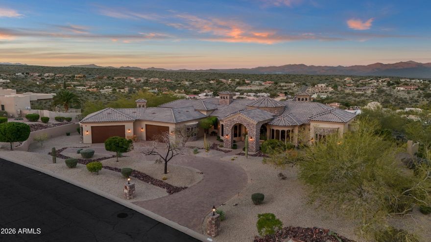 From the moment you arrive, the views define the experience. Set on over three acres on one of Fountain Hills' most prestigious ridges, this architecturally rich desert estate commands breathtaking panoramas of the surrounding mountains and iconic Four Peaks—views that greet you upon entry and remain ever-present throughout the home.

Designed for privacy and effortless single-level living, the residence is thoughtfully oriented to embrace its extraordinary setting. Expansive living spaces unfold with intention, creating a natural flow that feels both grand and inviting. Warm architectural details, timeless materials, and carefully framed sightlines ensure the landscape is never an afterthought, but a constant companion to daily life.

The heart of the home is anchored by gathering spaces that invite connection, whether for intimate moments or elegant entertaining. Walls of glass draw the outdoors in, while indoor spaces transition seamlessly to outdoor living areas designed to celebrate the scale and beauty of the desert. From sunrise to sunset, light and color move across the horizon, transforming the home throughout the day.

The primary suite offers a serene retreatprivately positioned to capture the views while providing a sense of calm and seclusion. Additional guest suites and flexible living spaces are thoughtfully placed to offer comfort, privacy, and versatility, each enjoying a relationship with the surrounding landscape.

Outdoors, the experience is nothing short of extraordinary. A dramatic double negative-edge pool and spa appear to spill into the desert beyond, creating an immersive vantage point for reflected sunsets and sweeping vistas. Multiple patios and gathering areas provide endless opportunities to pause, entertain, or simply take in the stillness and scale of the setting.

This is a residence where architecture and landscape exist in perfect balancea rare opportunity to own an architecturally rich estate defined by space, privacy, and truly unforgettable views.
