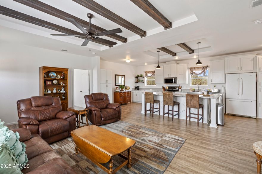 Discover this stunning 2-acre hilltop retreat! Perched high with breathtaking views, this beautiful property features a 2022 Schult manufactured home offering 1,706 square feet of thoughtfully designed living space. Inside, you'll find 3 spacious bedrooms, 2 full bathrooms, and an open-concept layout that seamlessly connects the main living areas. Stylish touches like barn doors, exposed ceiling beams, a central island, and a farmhouse sink give the home a warm and modern farmhouse charm.
Outside, the upgrades continue with a large, color-matched shed for additional storage, two expansive concrete pads, a generously fenced area perfect for pets, and landscaping featuring seven newly planted trees, including three productive Granny Smith apple trees. This hilltop haven offers not only privacy and panoramic views but also freedom with no HOA and plenty of space for animals. A chicken coop is already in place to help you kick-start your hobby farm dreams. A 2650 gallon tank is installed!  Well water flow rate of 1.5 GPM.
Conveniently located just minutes from the shopping and dining of Prescott Valley, and only 30 minutes from historic downtown Prescott, this exceptional property blends rural tranquility with modern convenience.