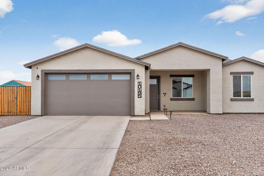 Step inside this beautifully crafted 2022 single level home and instantly feel the sense of calm that comes from thoughtful design and open, airy spaces. With 9 foot ceilings, natural light pouring in, and a layout that flows with ease, this 4 bed, 2 bath residence feels like the kind of place where life slows down just enough for you to savor it. The heart of the home is its spacious great room and modern kitchen complete with granite countertops, a generous island, and stainless steel appliances. Whether you're hosting Sunday brunch or enjoying a quiet morning coffee, this space is designed to bring people together. The split primary suite offers a peaceful retreat, featuring a beautifully tiled walk in shower, double vanity, and a roomy closet that makes everyday living feel effortless. Three additional bedrooms give you the flexibility to create a home office, guest space, or playroom.  Whatever your season of life calls for. Step outside to a large 7,341 sq ft lot with complete  fencing, offering privacy and room to dream. Add a garden, create an outdoor lounge, or bring in the toys, your RV gate makes it easy to store what fuels your adventures. Every detail, from the low maintenance landscaping to the modern finishes was chosen to make life simpler, warmer, and more enjoyable. And with no HOA and a peaceful Arizona City location, you get the freedom and space to truly make this home your own. This isn't just a house. It's the backdrop for birthday parties, quiet evenings on the patio, and the kind of everyday moments that become your favorite memories. Welcome home to the place where your next chapter begins.