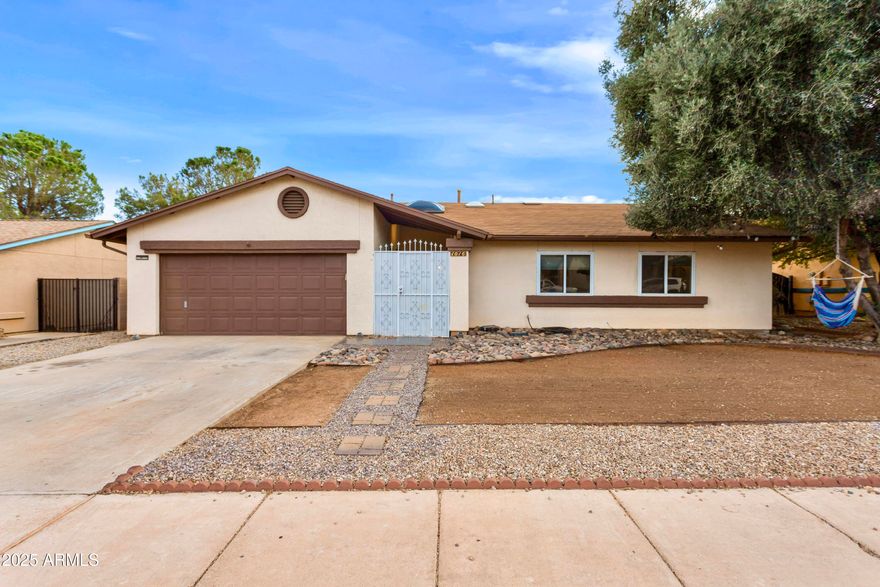 Stunningly updated 3 bedroom, 2 bathroom, 2 car garage home with fully fenced backyard. This beautiful property shines with pride of ownership & care. Vaulted ceilings will greet you as you pass through the gated atrium area. Wood look tile throughout the home with carpet only in the bedrooms. Spacious laundry room area with ample storage space. Freshly rocked back yard with covered back patio is ready for your personal touches!