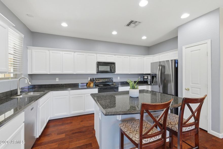 PAID-OFF SOLAR just minutes from Downtown Gilbert! Located in the highly sought-after Village at Gilbert & Warner, this beautifully updated home offers privacy, efficiency, and an unbeatable location. With only one direct neighbor, enjoy open views and extra natural light rarely found in the community. Inside features a bright open floorplan with brand new white kitchen cabinets, upgraded flooring, neutral paint, and a large kitchen island perfect for entertaining. Upstairs offers 3 spacious bedrooms, including a split primary suite and upstairs laundry. Major updates include newer A/C (2019) and brand new water heater (2026). Community pool, greenbelts, playgrounds & more!