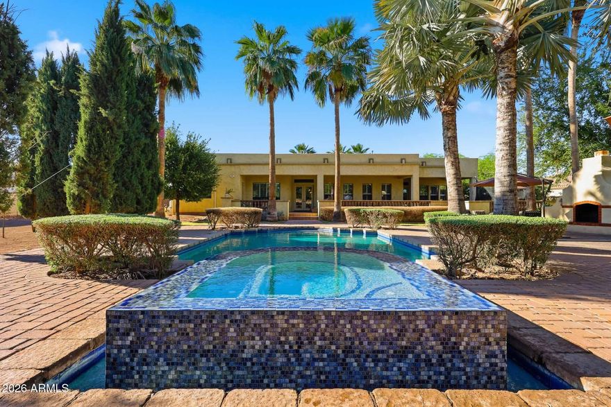 Elevate Your Lifestyle in This Stunning Tuscan-Inspired Estate! 

Step into timeless elegance with this breathtaking 3-bedroom plus den (opt 4th), 3.5-bathroom Vanderbilt Farms custom home offering over 3,600 square feet of refined living space on a 1 acre irrigated homesite. 

Designed to capture the warmth and romance of a rustic Tuscan villa, this residence blends old-world charm with modern luxury.
From the moment you enter, soaring 10-15-foot ceilings create a sense of grandeur, while rich textures and natural materials establish an inviting, sophisticated atmosphere throughout.

Interior Highlights: Interior Highlights:

·  Solid Alderwood cabinetry offering warmth, richness, and custom craftsmanship

·  Commercial-grade KitchenAid appliances for exceptional culinary performance
·        Elegant granite countertops that enhance both beauty and functionality
·        4-piece tumbled and chiseled Turkish travertine flooring throughout
·        8-foot solid core doors providing a seamless, upscale flow
·        6" white wood shutters throughout, adding timeless style and light control
·        2x6 construction with R-21 wet cellulose wall insulation and R-50 attic insulation for superior energy efficiency
·        5/8" solar board sheathing across the entire home for enhanced thermal performance

Outdoor & Lifestyle Features:
·        Over 10,000 sq. ft. of old-world pavers creating a stunning, cohesive outdoor environment
·        Resort-style Pebble Tec pool with a negative edge spa for a true luxury experience
·        Expansive outdoor kitchen with oversized bar seating--perfect for entertaining
·        Extended covered patio spanning the rear of the home, set on an elevated deck overlooking the resort-style backyard
*        Grand outdoor fireplace for relaxing evenings and gatherings under the stars
·        Dedicated garden area with five raised beds for fresh herbs and vegetables
·        Mature fruit and nut trees, including tangelo, white grapefruit, apple, pecan, olive, pomegranate, lime, and multiple lemon varieties

This exceptional property offers the perfect blend of luxury, comfort, and natural beauty--creating a private retreat designed for both everyday living and unforgettable entertaining.

Opportunities like this are rare. Don't let it slip by...